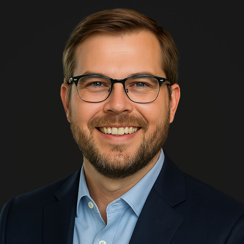 Headshot of Bryan Thomas with glasses and beard